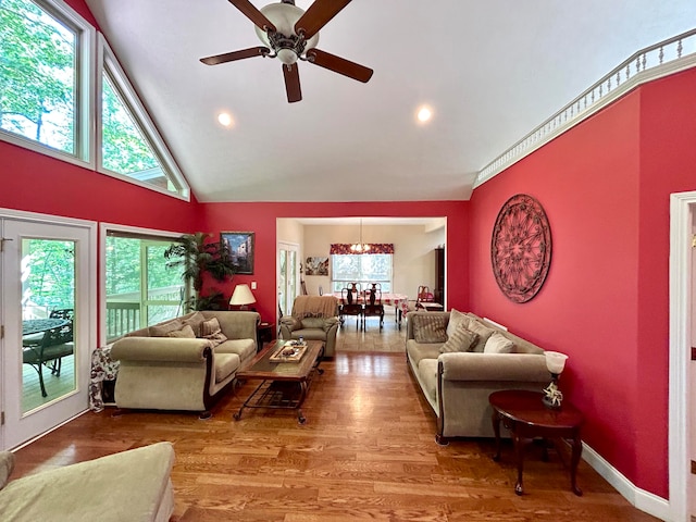 living room with high vaulted ceiling, wood-type flooring, and ceiling fan