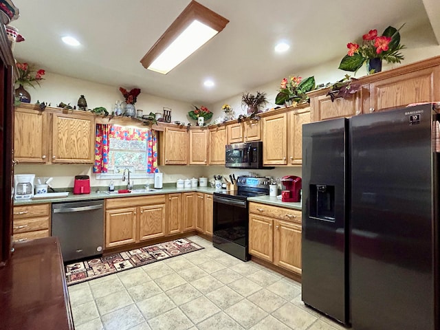 kitchen with black appliances, sink, and light tile floors