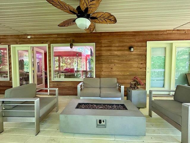 exterior space with wood walls and ceiling fan