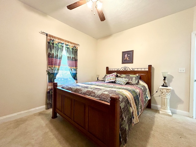 bedroom featuring light carpet and ceiling fan