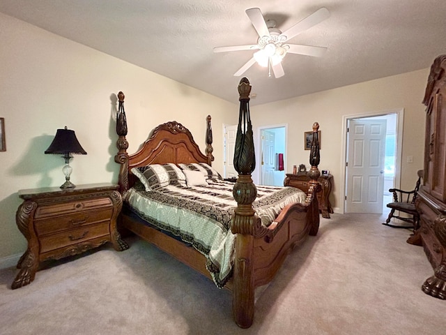 carpeted bedroom featuring ceiling fan and a textured ceiling