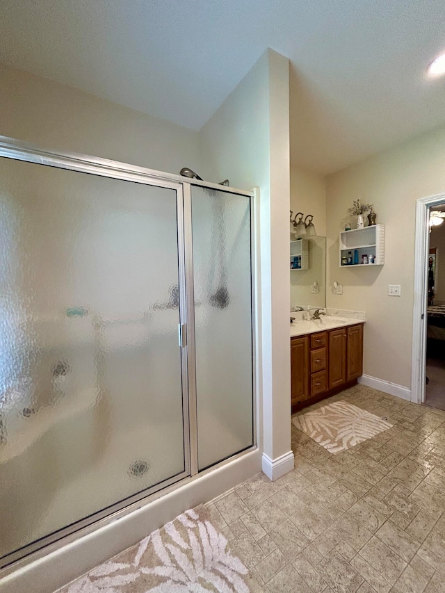 bathroom with an enclosed shower, oversized vanity, and tile floors