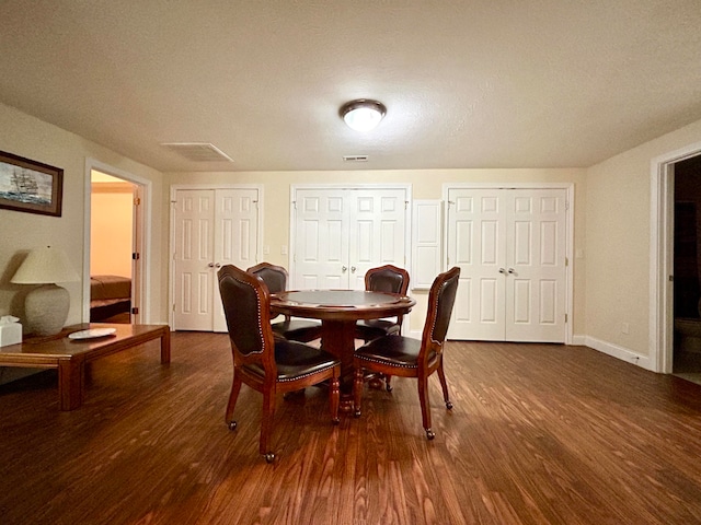 dining space with dark wood-type flooring