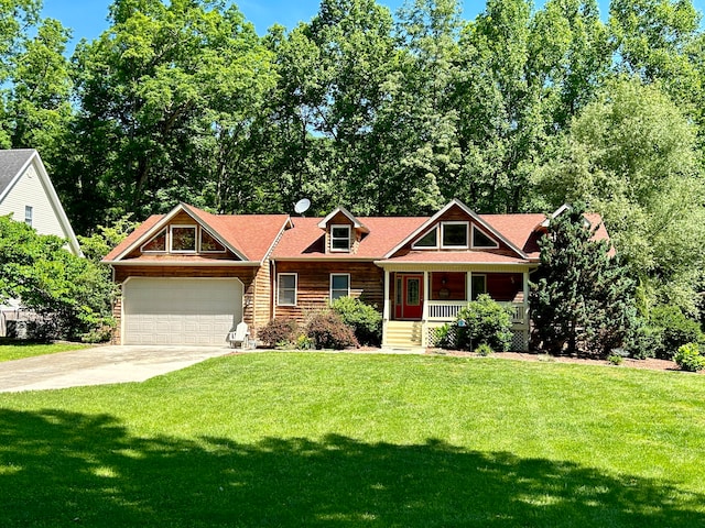 view of front of property featuring a garage, a front yard, and a porch