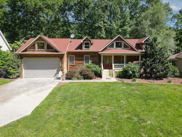 view of front of home with a front lawn, a garage, and covered porch