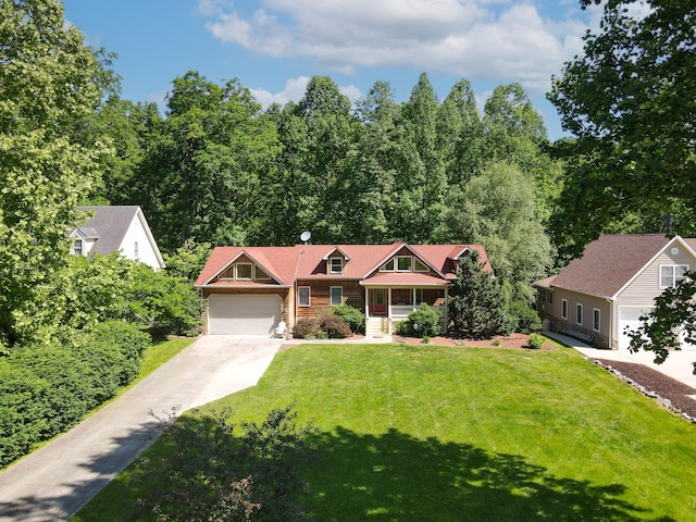 view of front of property with a garage and a front lawn