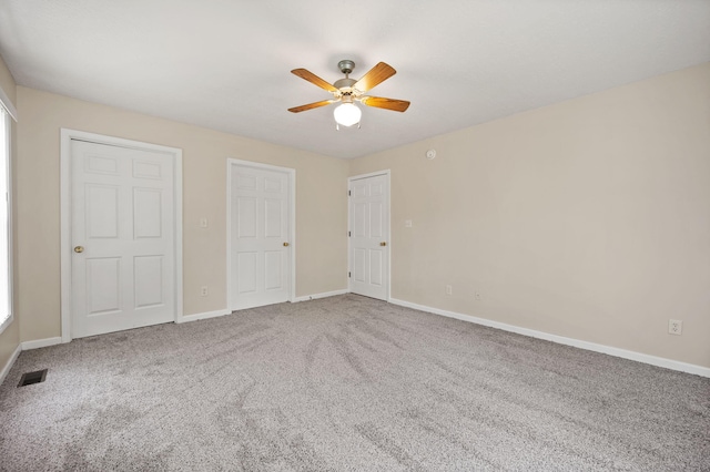 unfurnished bedroom featuring ceiling fan and carpet