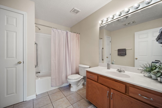 full bathroom with a textured ceiling, toilet, tile patterned floors, vanity, and shower / bathtub combination with curtain