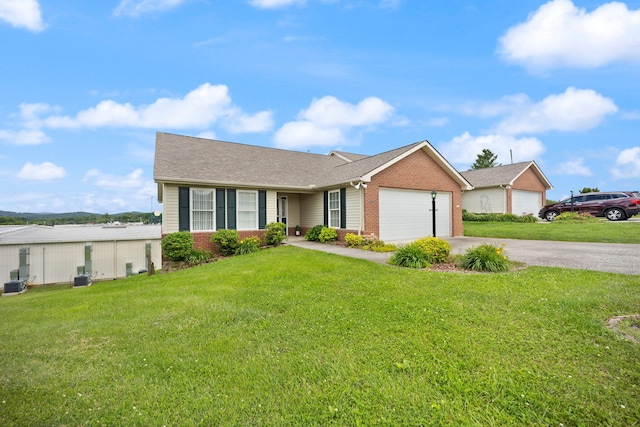 ranch-style home with a front lawn and a garage