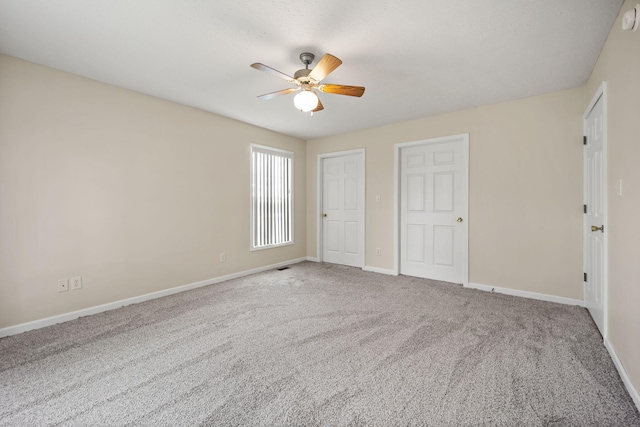 unfurnished bedroom with ceiling fan and carpet