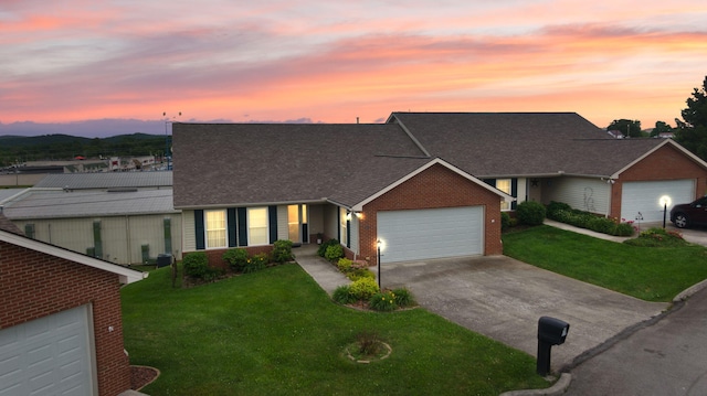 ranch-style house with a yard and a garage