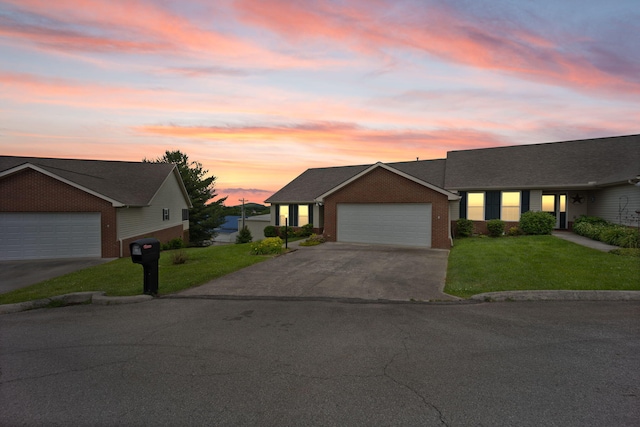 view of front of house featuring a yard and a garage