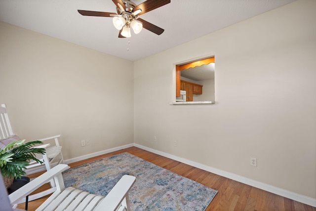 unfurnished room with ceiling fan and hardwood / wood-style flooring