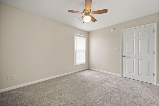 empty room with carpet and ceiling fan