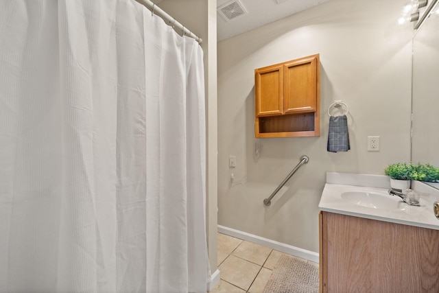 bathroom with tile patterned floors and vanity