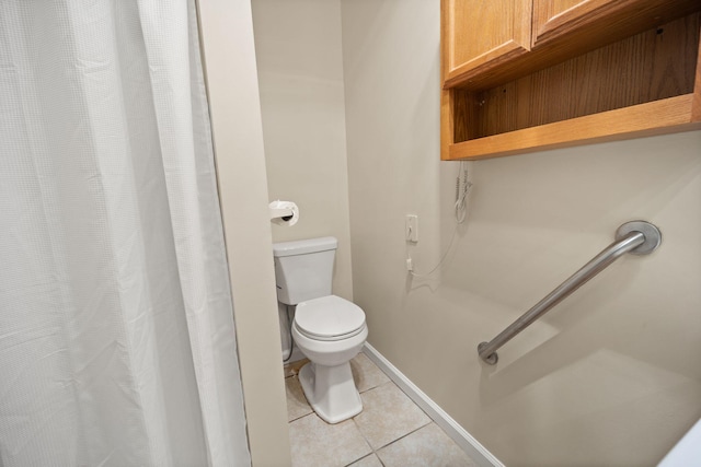 bathroom with tile patterned floors and toilet