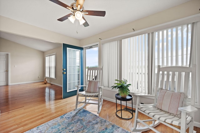 sitting room with ceiling fan, light hardwood / wood-style flooring, and vaulted ceiling