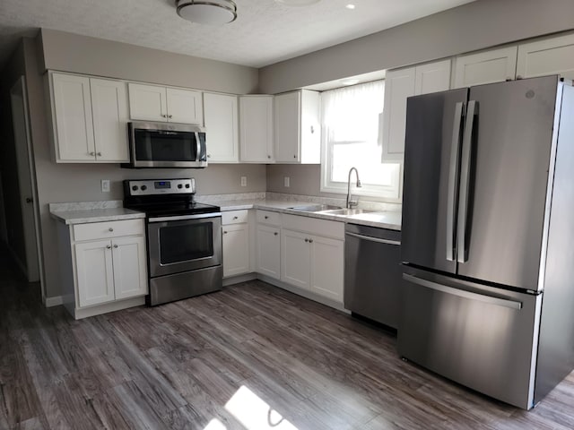 4104 Brooksville-Germantown Rd, Augusta, KY 41002 - kitchen featuring appliances with stainless steel finishes, a sink, white cabinetry, light countertops, and dark wood-type flooring