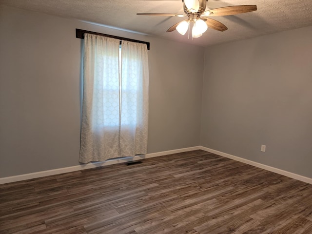 spare room featuring ceiling fan, dark hardwood / wood-style flooring, and a textured ceiling