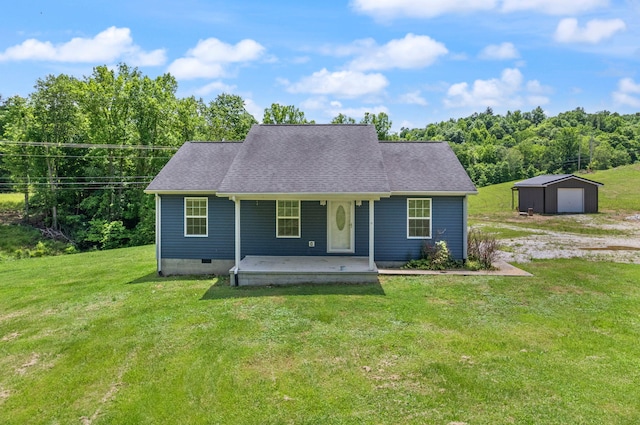 view of front of house featuring an outbuilding, a porch, a garage, and a front lawn