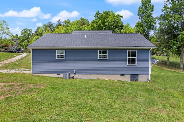 rear view of property with a yard and central AC unit