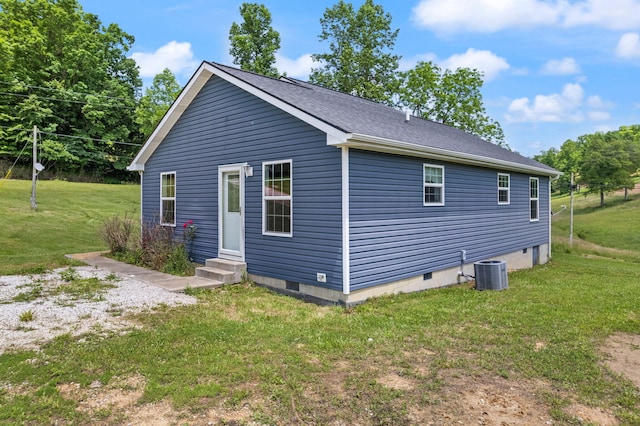 exterior space featuring a yard and central AC unit