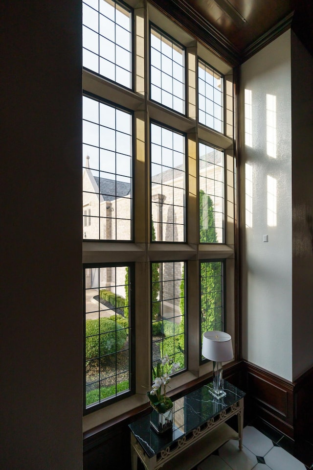 doorway to outside with crown molding and plenty of natural light