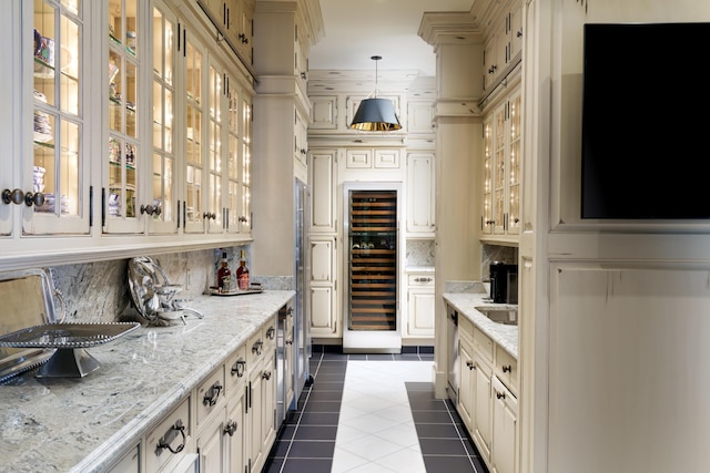 bar featuring light stone countertops, tasteful backsplash, decorative light fixtures, light tile patterned flooring, and beverage cooler