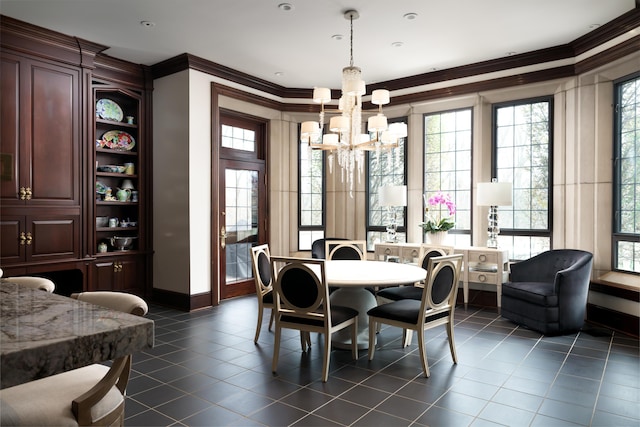 tiled dining space with crown molding, a healthy amount of sunlight, and an inviting chandelier