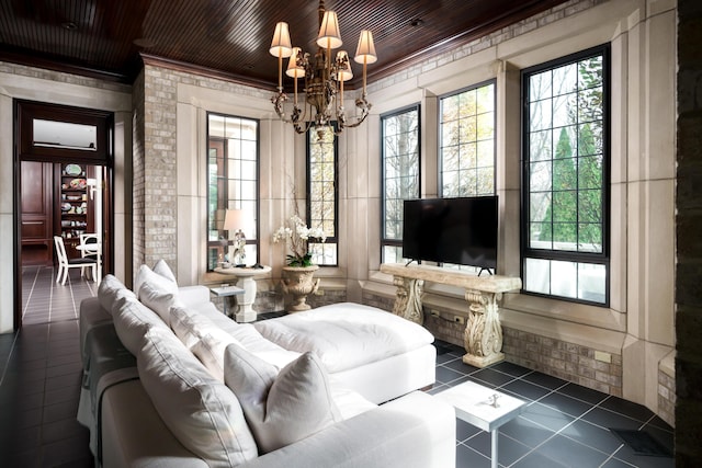 living room with a chandelier, dark tile patterned flooring, crown molding, and wood ceiling