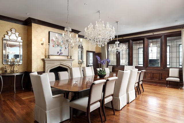 dining space with hardwood / wood-style floors, a chandelier, and ornamental molding