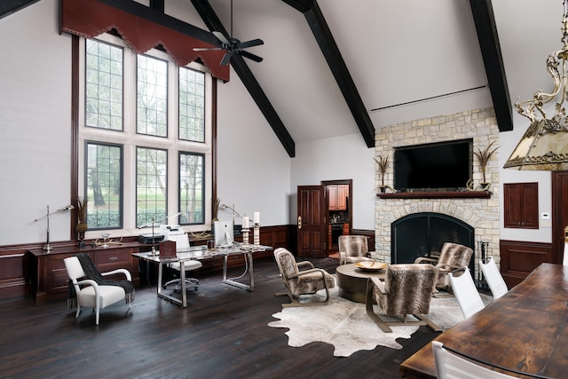 living room featuring high vaulted ceiling, ceiling fan, dark wood-type flooring, and a stone fireplace