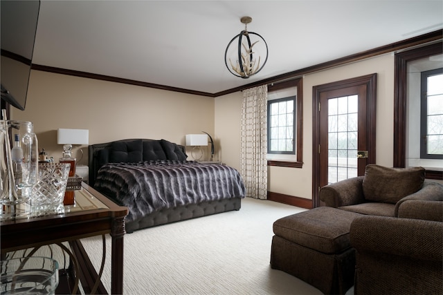 carpeted bedroom featuring a notable chandelier and ornamental molding