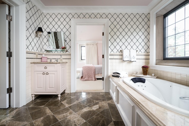 bathroom featuring a tub, vanity, and ornamental molding