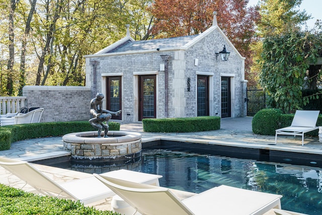 view of swimming pool featuring an outbuilding