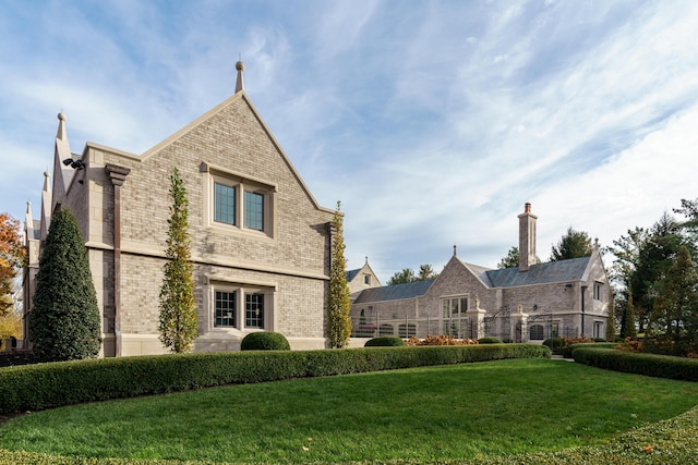 view of property exterior featuring a lawn