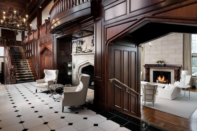 interior space featuring a chandelier, beam ceiling, a towering ceiling, and wooden walls