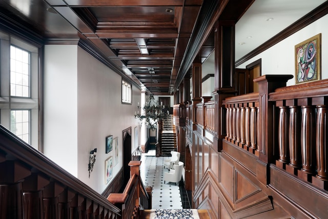 hallway featuring plenty of natural light, crown molding, and coffered ceiling