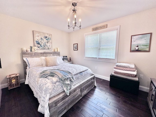 bedroom with dark hardwood / wood-style flooring and a notable chandelier