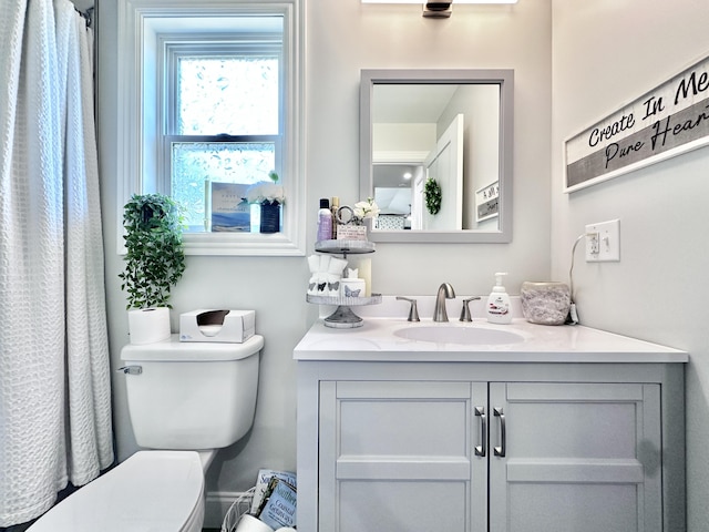 bathroom featuring toilet and vanity