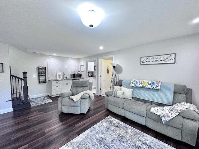 living room with dark hardwood / wood-style flooring