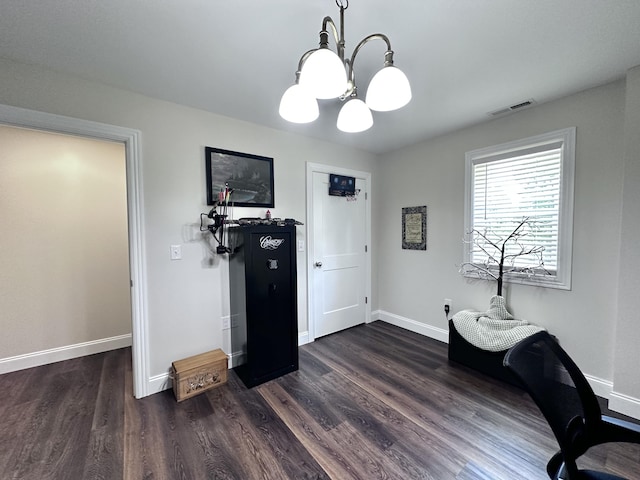 office with dark hardwood / wood-style floors and an inviting chandelier