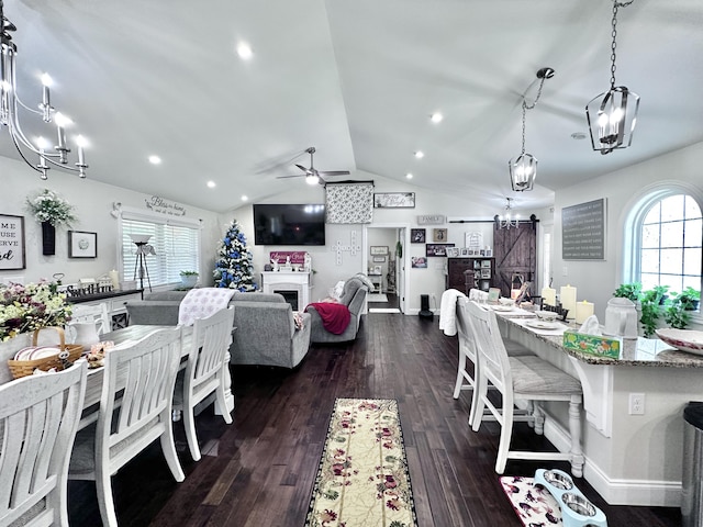 dining room with ceiling fan, dark wood-type flooring, plenty of natural light, and a barn door