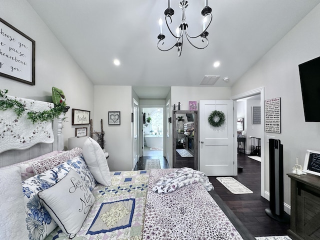 bedroom with dark wood-type flooring and a chandelier