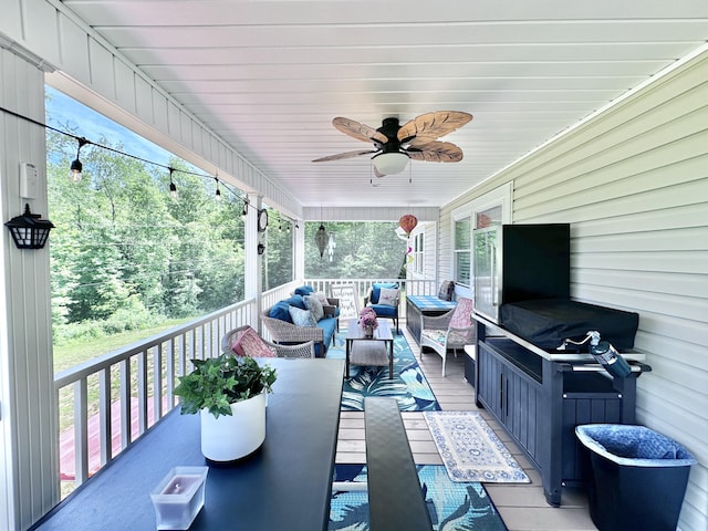 wooden deck with ceiling fan and an outdoor living space