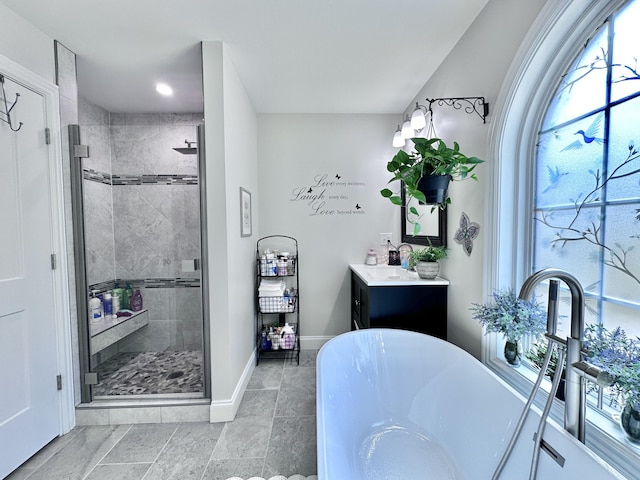 bathroom featuring shower with separate bathtub and vanity