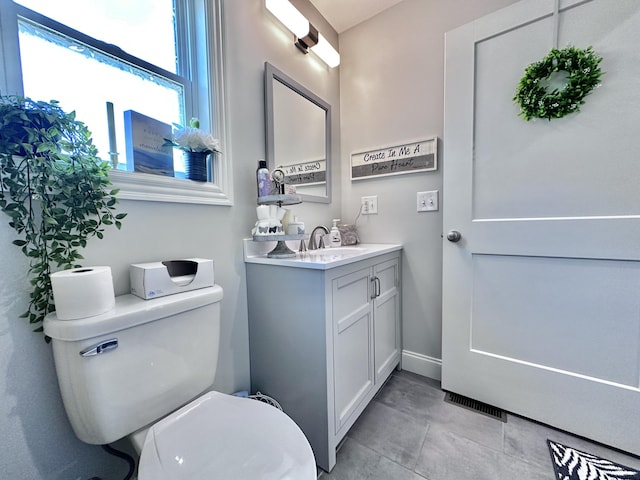 bathroom with toilet and vanity