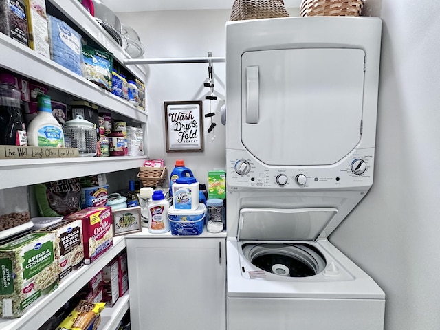 laundry area featuring stacked washer / drying machine