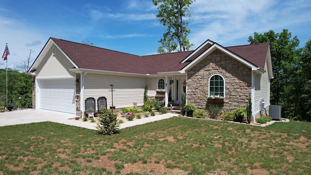 view of front of property featuring a garage, a front lawn, and central air condition unit