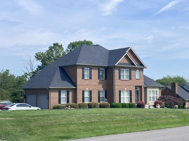 view of front of house featuring a front lawn and a garage